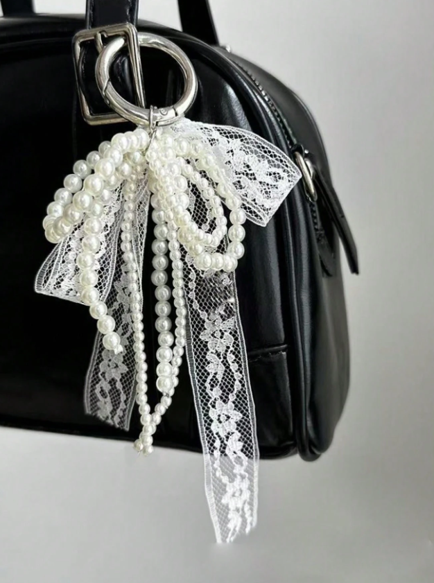 Cutie Charm with a white lace and pearl bow ribbon - Kamuxury